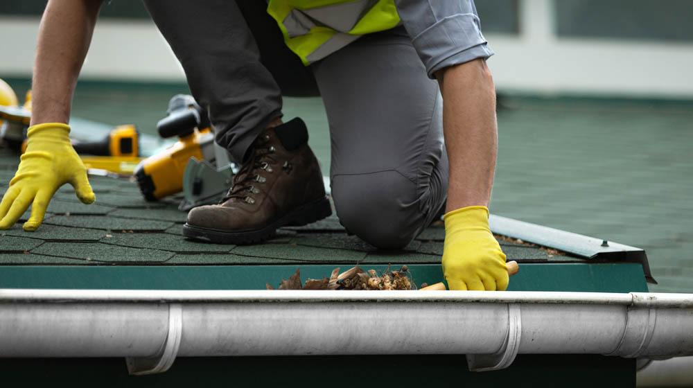 Hewatt technician clearing roof and gutter debris Hewatt technician clearing roof and gutter debris